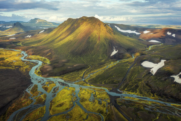 Wandering through Iceland's highlands, I stumbled upon this ethereal landscape. The soft curves of the river contrasted beautifully against the sharp peaks of the mountains, creating a truly magical scene. -