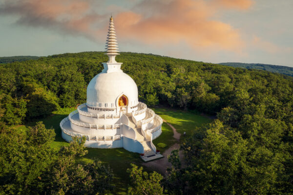 ..the pristine white stupa stands bathed in the soft glow of dawn. Witnessing its beauty in the first light of day evokes a profound sense of peace and spiritual awakening. -