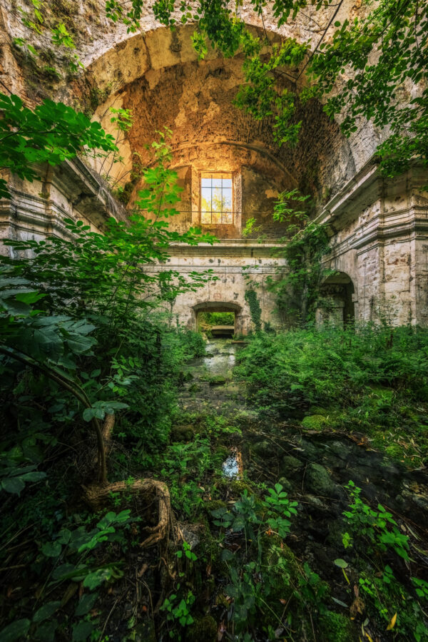 abandoned church through which a small river flows -