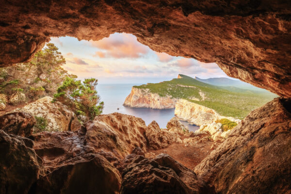 ..a hidden gem on the rugged coast of Sardinia. This small, natural cave offers breathtaking panoramic views of the Mediterranean Sea and the surrounding cliffs. -