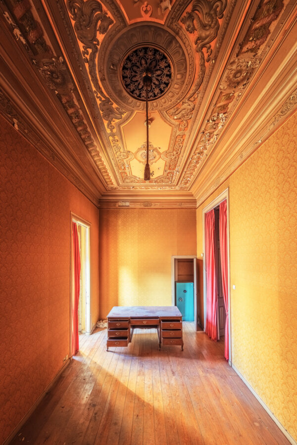 small room in a large opulent palace. -