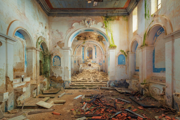 sunlight, once filtering through stained glass windows, now casts long, dancing shadows on the crumbling altar -