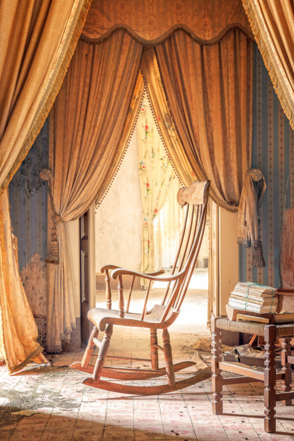 she would spend hours in this room, rocking gently back and forth, a book resting on her lap. -