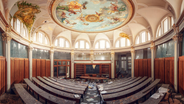 an abandoned auditorium with an impressive ceiling -