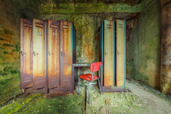 the air was thick with the smell of dampness and decay as I stepped into the forgotten locker room. -