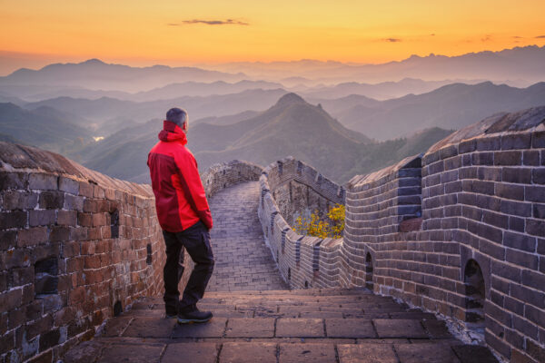 It's a quote from Mao and it means: one who fails to reach the Great Wall cannot be called a man -