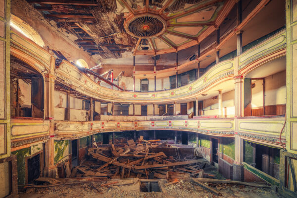 ...stage boards scattered across the auditorium of a decaying theatre.