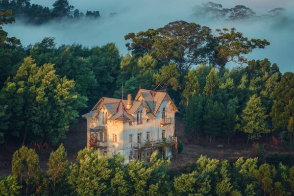 ..while fog cleared around the mountain villa, sunlight cut through the clouds and illuminated the scene.